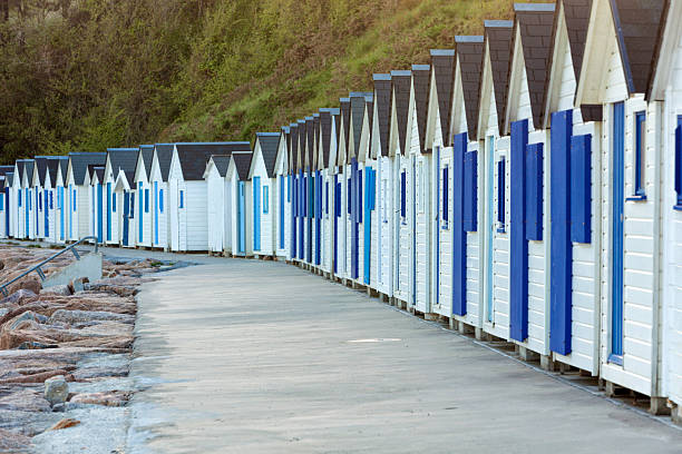 Row of blue and white beach huts at Barneville-Cartert, Cotentin peninsula, Normandy, France