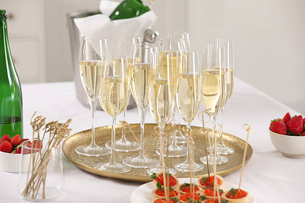 istock Champagne, strawberries and canapes with red caviar on white table 2232510909