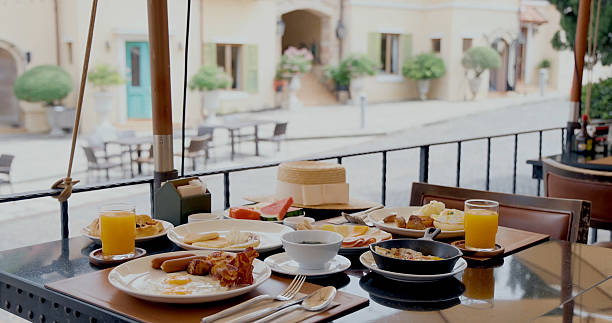 istock Outdoor cafe breakfast setting with sunny village street view, 2232513962