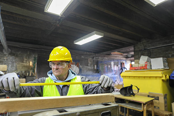 istock Skilled Laborer in Reflective Vest Inspecting Timber Indoors 2232514630
