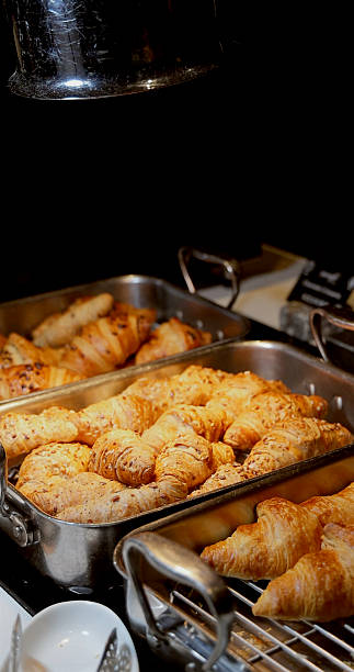 Fresh croissants displayed in bakery setting, highlighting gourmet