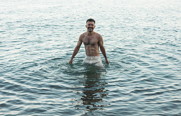 istock Handsome guy relaxes by the ocean 2232515904
