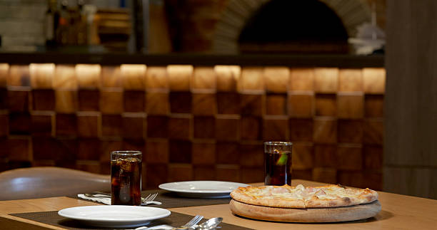 istock Pizza and drinks on restaurant table, cozy dining scene in rustic 2232516419