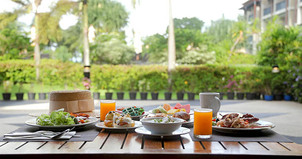 istock Tropical breakfast setting outdoors with fresh juice, pastries, salad 2232516795