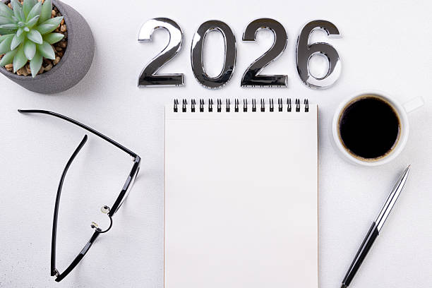 istock 2026 New year resolutions on desk. 2026 goals list with notebook, coffee cup, plant on white background. Resolutions, plan, goals, action, checklist, idea concept. New Year 2026 resolutions 2232517853
