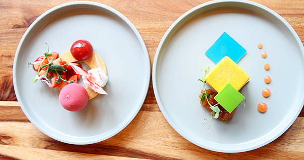 Gourmet molecular gastronomy dishes artfully presented on wooden table