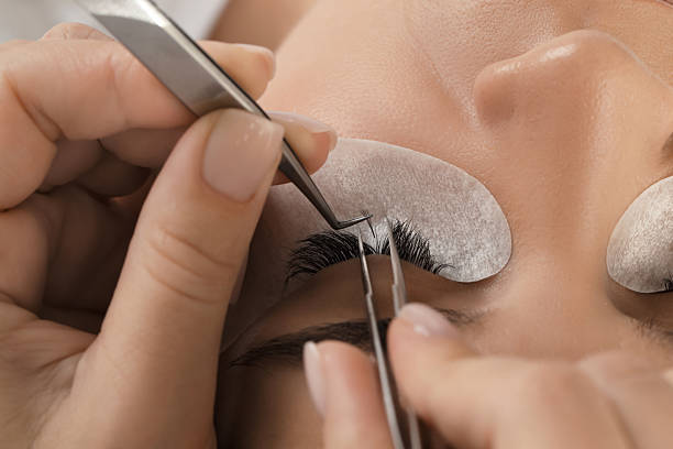 istock Young woman undergoing lash extensions procedure, closeup 2232518585