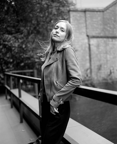 istock Young woman leaning on railing in urban setting, black and white 2232519584