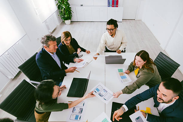 istock Business team exchanging documents during a meeting in the office 2232519863