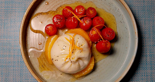 istock Burrata and cherry tomatoes on rustic ceramic plate. Italian cuisine, 2232520030