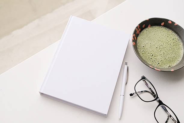istock blank book mockup on white coffee table with green matcha tea near window 2232520181