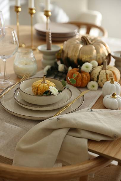 istock Stylish table setting with beautiful dishware and autumn decor in dining room 2232521174