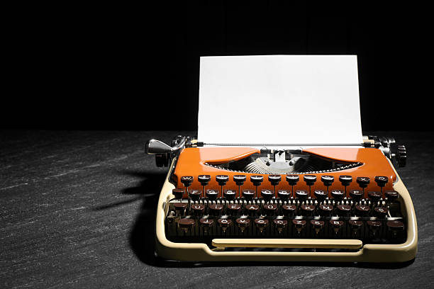istock Vintage typewriter with sheet of paper on black background. Space for text 2232522804