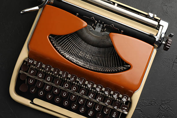 Vintage typewriter on black background, top view