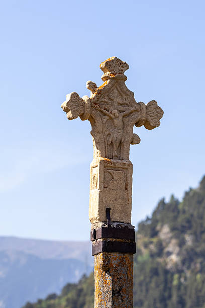 Stone cross standing tall against a clear blue sky