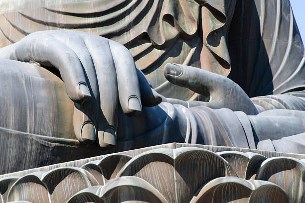 istock hands and leg of the Buddha statue 2232525037