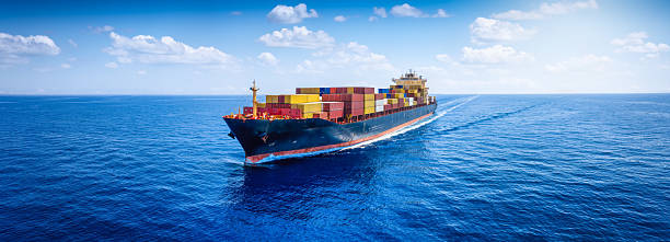 istock Panoramic aerial view of a loaded container cargo carrier ship sailing over the open ocean 2232527000