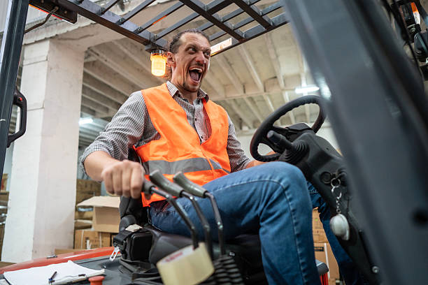 istock Warehouse Worker Driving a Forklift Expressing Enthusiasm and Excitement 2232527748