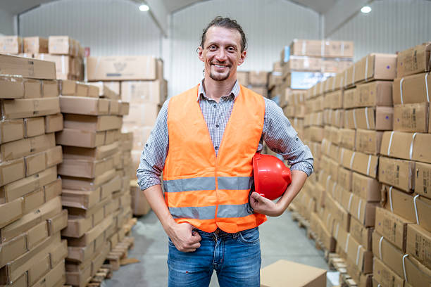 istock Warehouse Worker Holding Safety Helmet in Distribution Center 2232528122