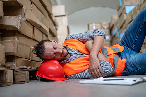 istock Tired Worker Resting in Warehouse During Workday on Cardboard Boxes 2232528161