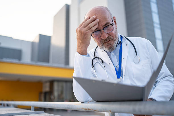 istock Concerned Doctor Reviewing Patient Case Files in a Modern Urban Setting 2232528734
