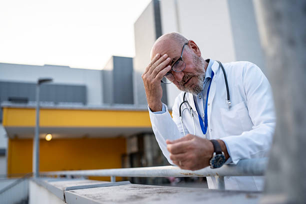 A close-up of a healthcare worker in a white coat, holding a stethoscope in front of them, ready for examination.