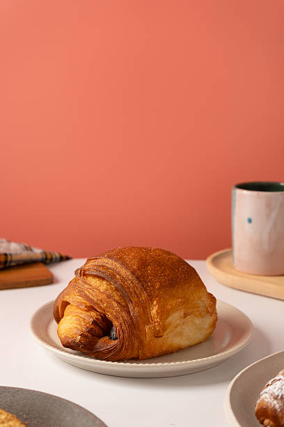 istock Pain au chocolat on a pink background 2232529204