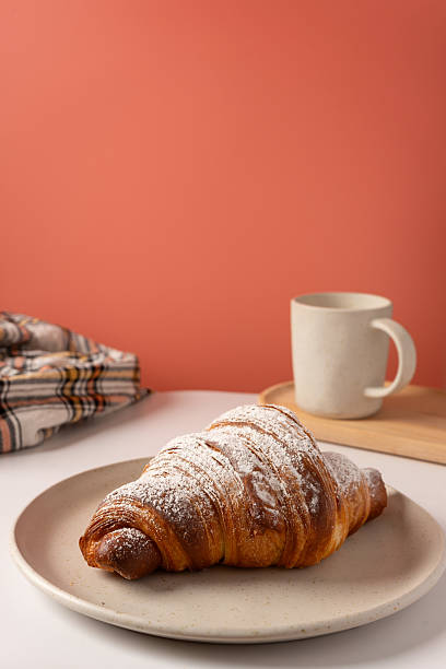 Sprinkled croissant on a pink background