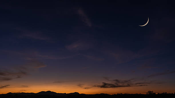 istock Cresent moon on dusk sky background, Twilight sky clouds over landscape mountain in summer evening, Religion of Islamic and free space text Ramadan Kareem, Eid Al Fitr, Eid Al Adha, Eid Mubarak 2232529375