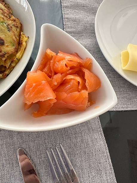 Fresh smoked salmon slices in white bowl