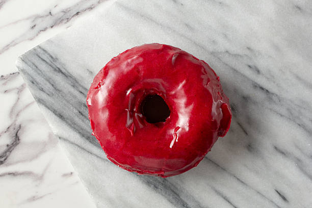 A top down view of a boysenberry donut.