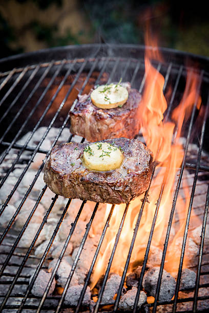 istock Juicy Steaks Grilling on an Open Flame with Herb Butter 2232529983