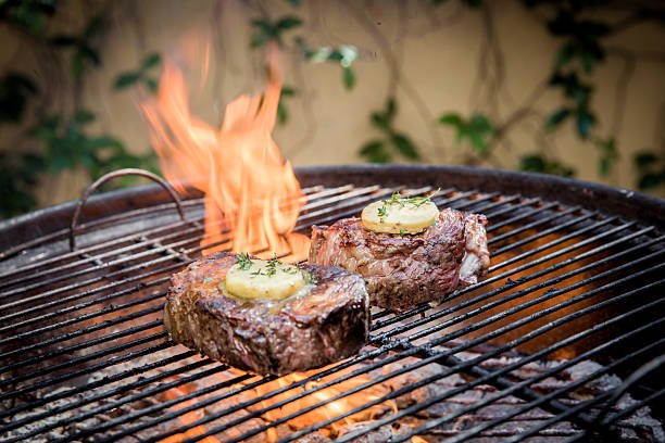 istock Grilling Juicy Steaks over Open Flame on Summer Afternoon 2232530004