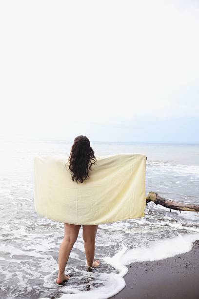 istock Young Lady Embracing the Coastal Wind 2232530809