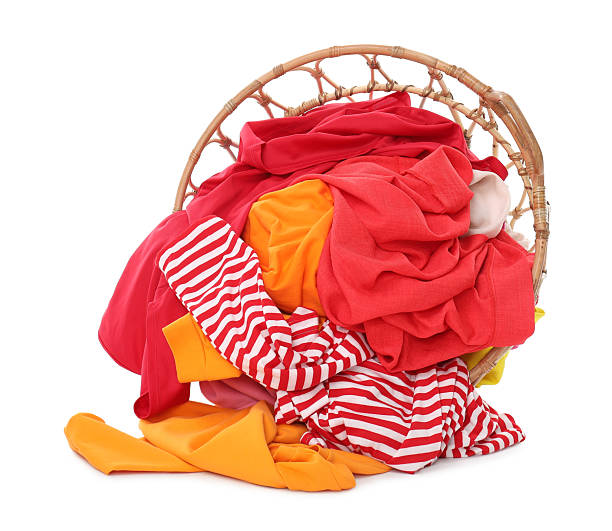 istock Laundry basket with colorful clothes isolated on white 2232532669