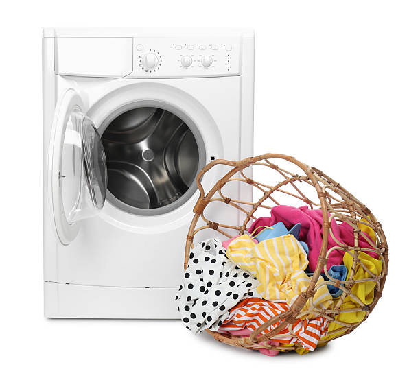 istock Washing machine and laundry basket with colorful clothes isolated on white 2232532693