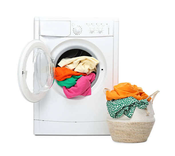 istock Washing machine and laundry basket with colorful clothes isolated on white 2232532739