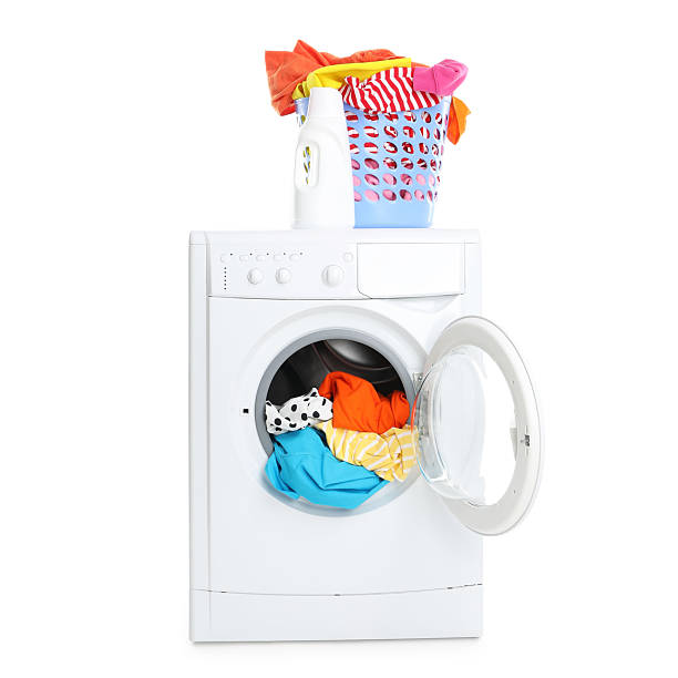 istock Washing machine, detergent and laundry basket with colorful clothes isolated on white 2232532792