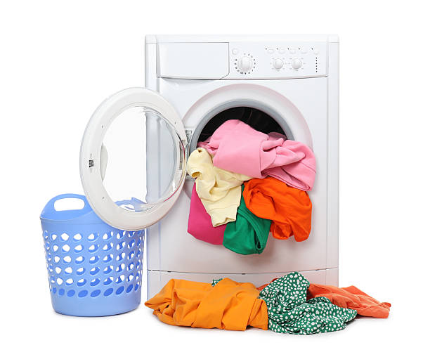 istock Washing machine with colorful clothes and basket isolated on white 2232532816