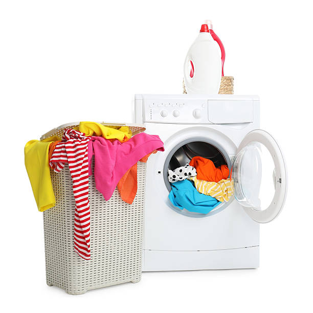 istock Washing machine, detergents and laundry basket with colorful clothes isolated on white 2232532820