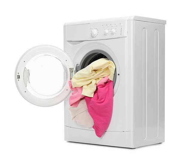 istock Washing machine full of colorful clothes isolated on white 2232532821