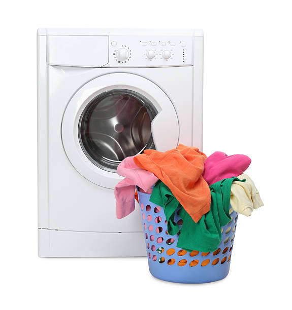 istock Washing machine and laundry basket with colorful clothes isolated on white 2232532839