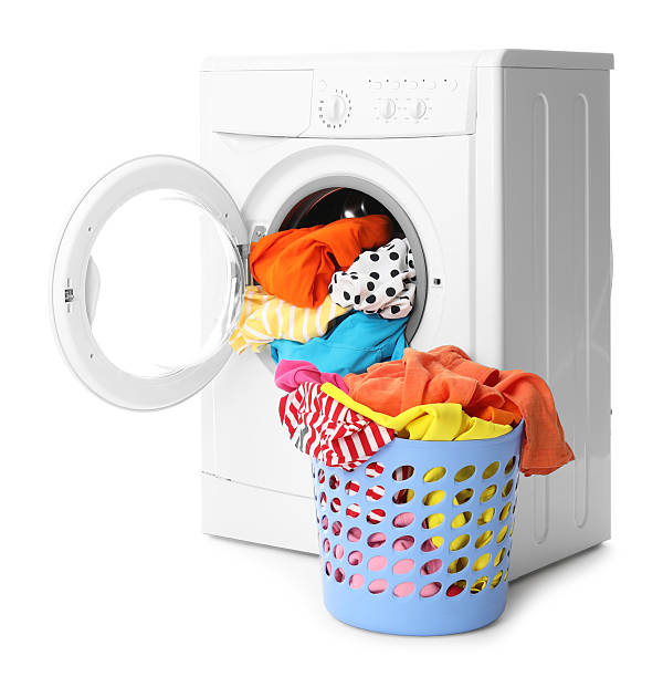 istock Washing machine and laundry basket with colorful clothes isolated on white 2232532861