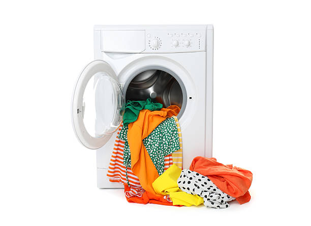 istock Washing machine with colorful clothes isolated on white 2232532872
