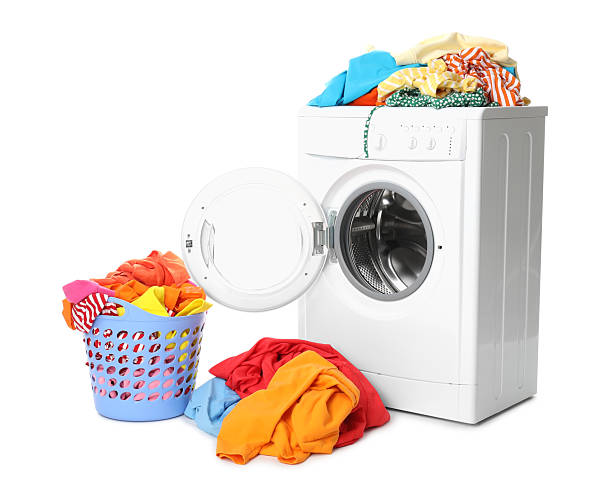 istock Washing machine and laundry basket with colorful clothes isolated on white 2232532889