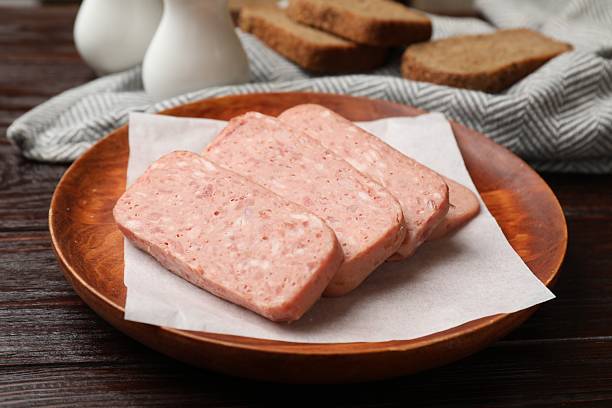 istock Canned meat and bread on wooden table, closeup 2232534205