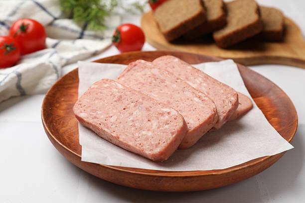 istock Canned meat on white tiled table, closeup 2232534215