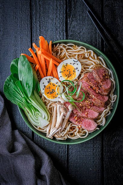 istock Delicious Japanese Ramen Bowl With Fresh Vegetables, Soft-Boiled Egg, and Steak 2232534352
