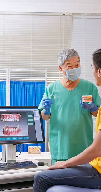 istock elderly dentist introduce transparent and wire braces 2232536661