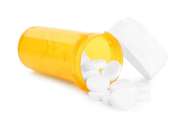istock Antibiotic pills with medical bottle and cap on white background 2232536830